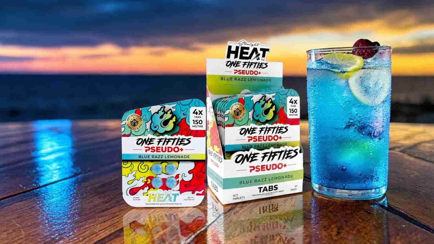 Three colorful food packages beside a blue cocktail at sunset.