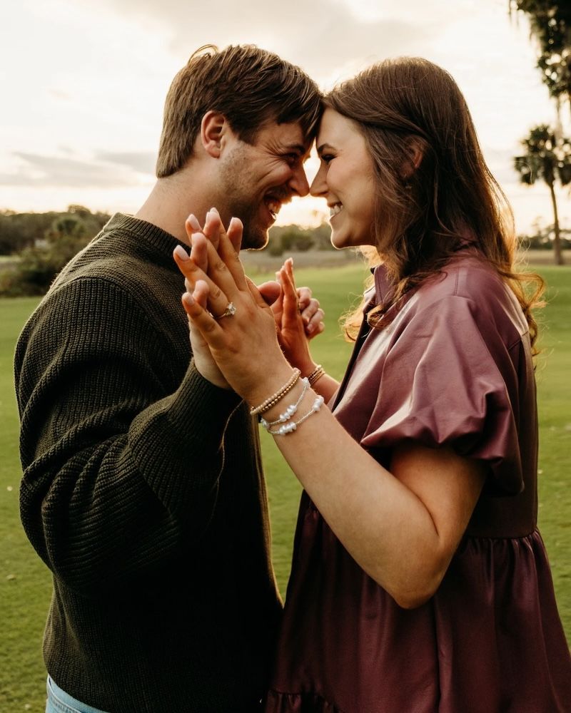 engaged couple celebrating, foreheads touching