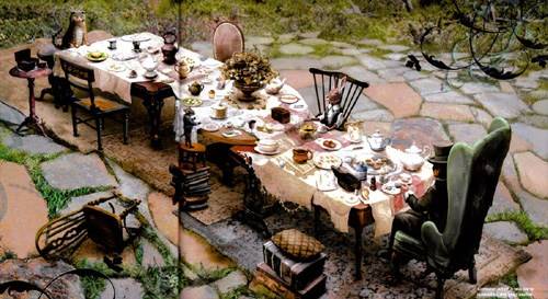 Image of long table set up like a Mad Hatter Tea Party.