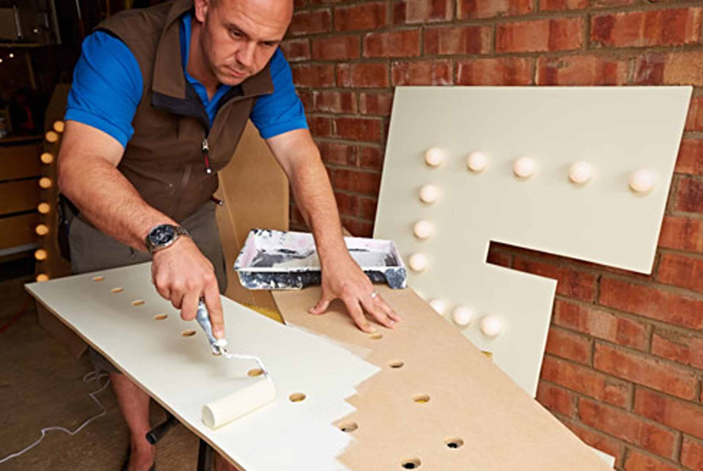 Painting wooden letters with a roller