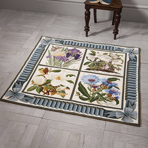 Four panel rug with blue ribbon and bow border
