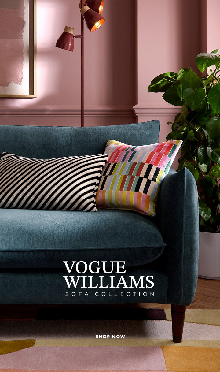 Sofa with colourful cushions against a modern wall backdrop.