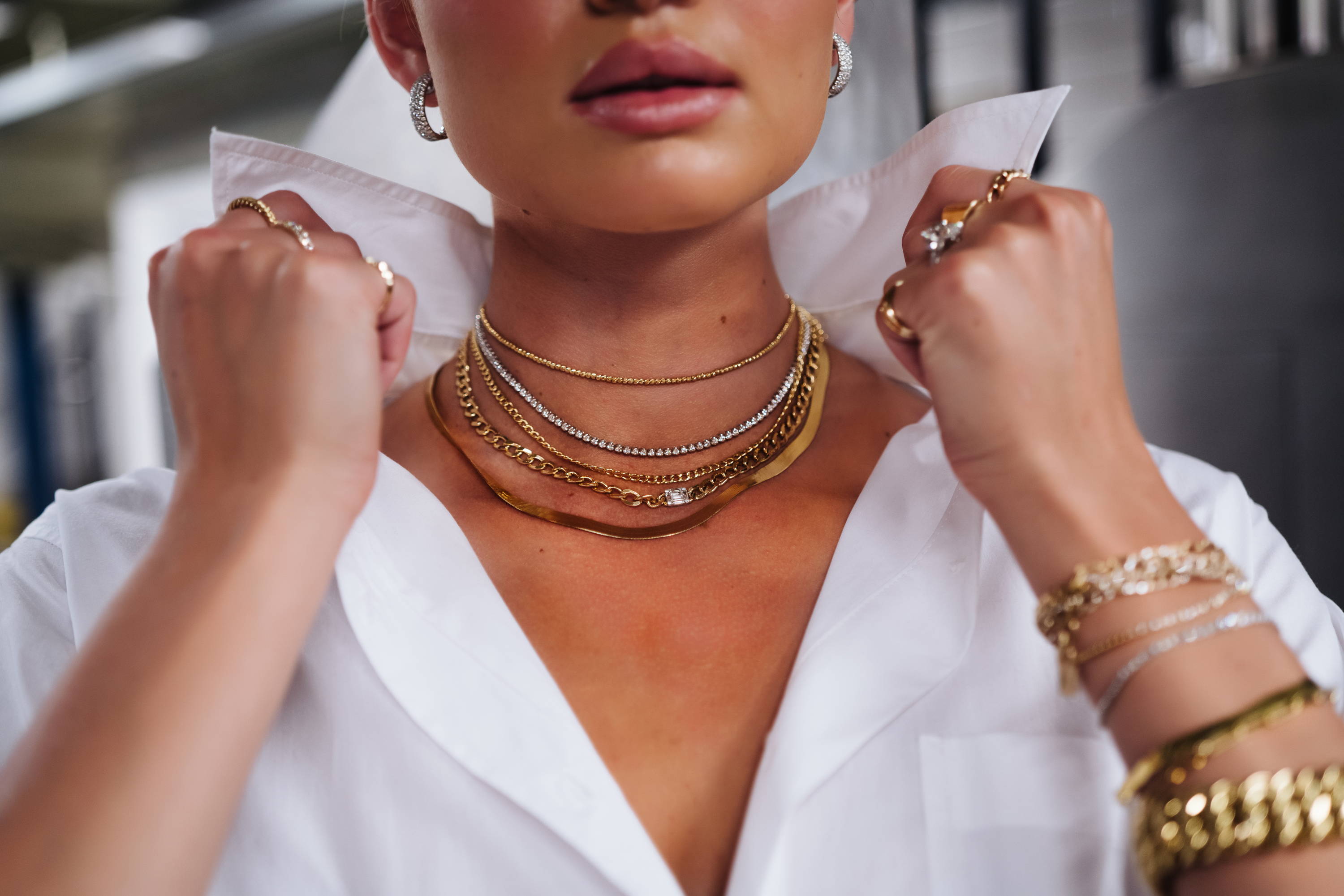 Model popping her collar wearing Ring Concierge fine jewelry