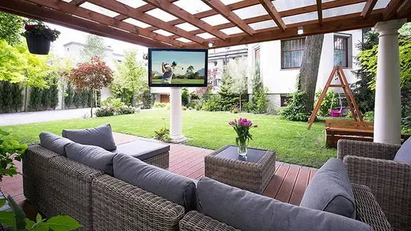 The TV Shield weatherproof outdoor TV enclosure ceiling mounted to pergola on detached patio