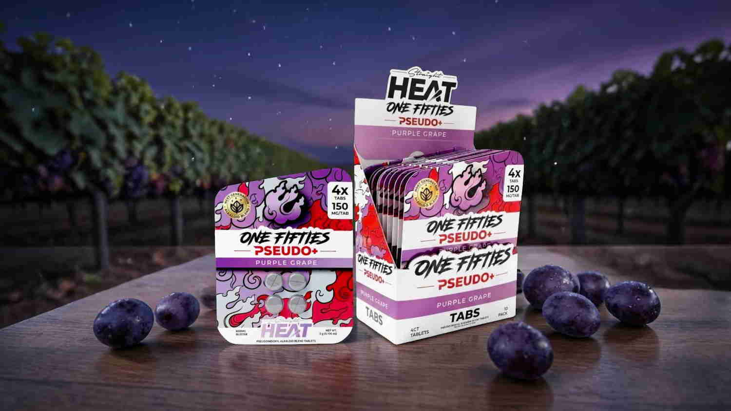 Three packages of candy with grapes in a vineyard setting at dusk.