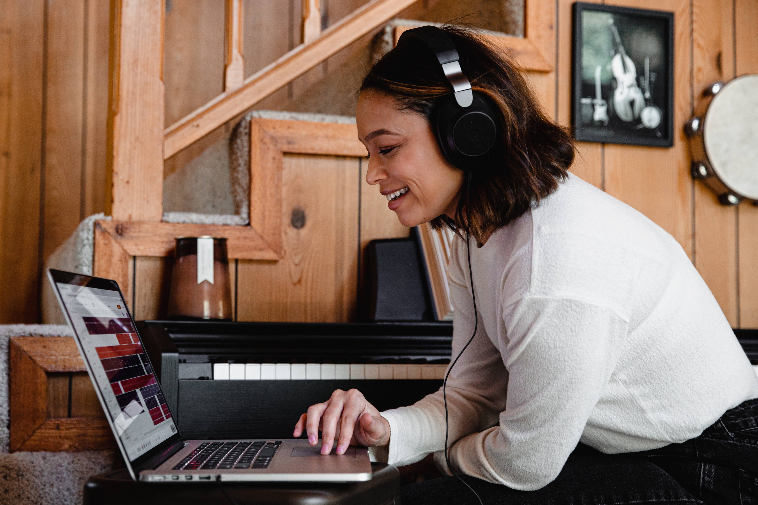 woman listening to headphones on a laptop