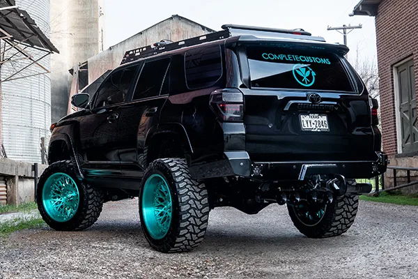 Rear three-quarter black 4Runner COMPLETECUSTOMS teal decal turquoise wheels steel bumper Texas plate Kealoha's 244K Spare Tire Delete gallery photo 4