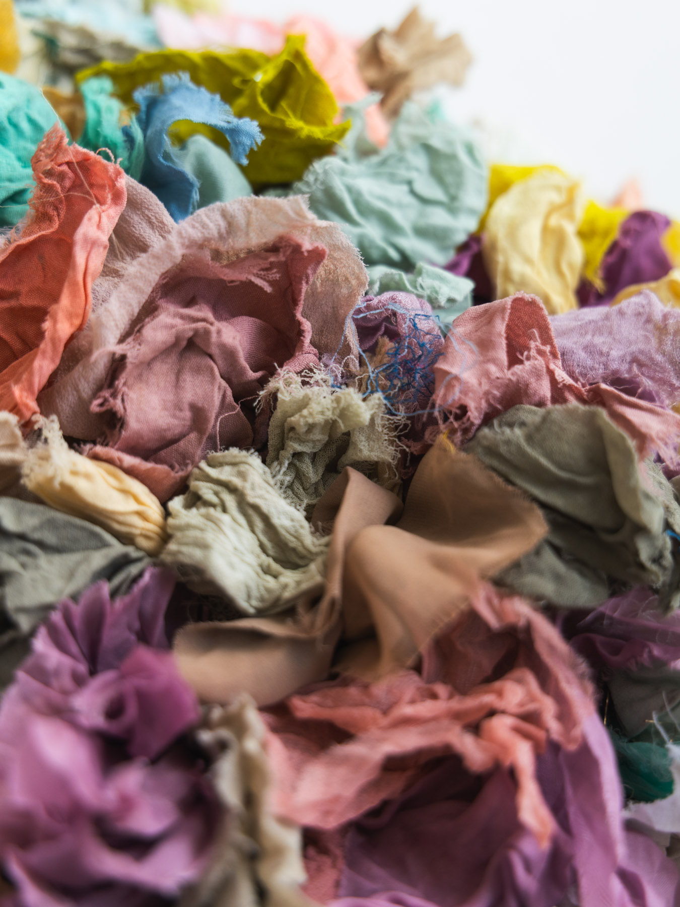 Colorful crumpled paper pieces in various shades and textures.