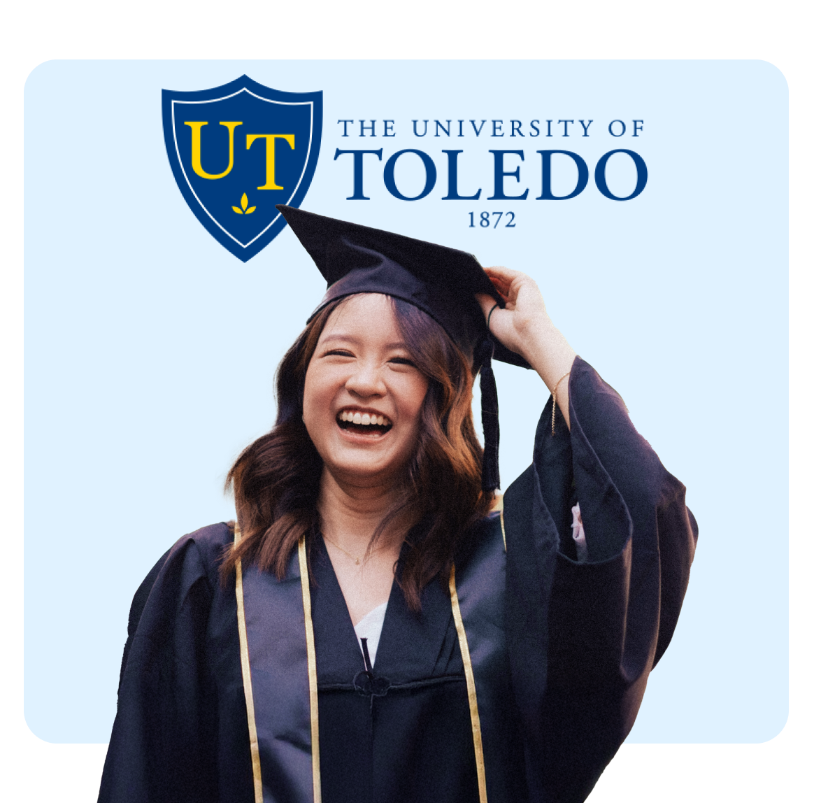 Smiling graduate in cap and gown celebrating at the University of Toledo.