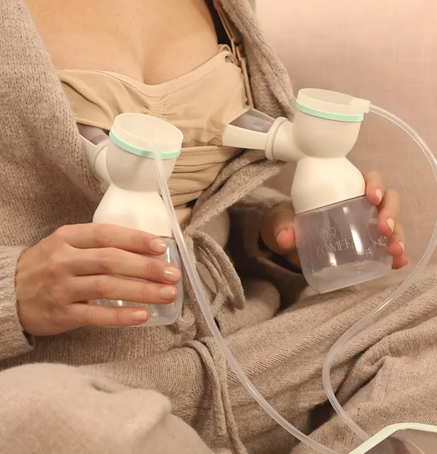 Mom using the Mother's Nature™ Breast Shield Kit