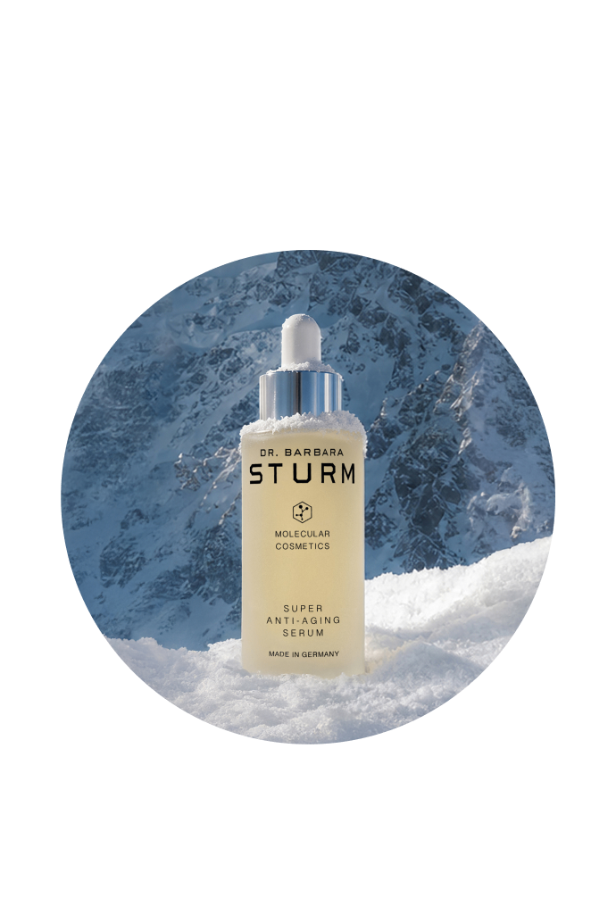 Dr. Barbara Sturm skincare serum bottle in a snowy mountain background.