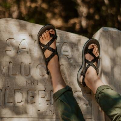Woman with feet in air wearing Cortona Outdoor Sandals by Viakix 