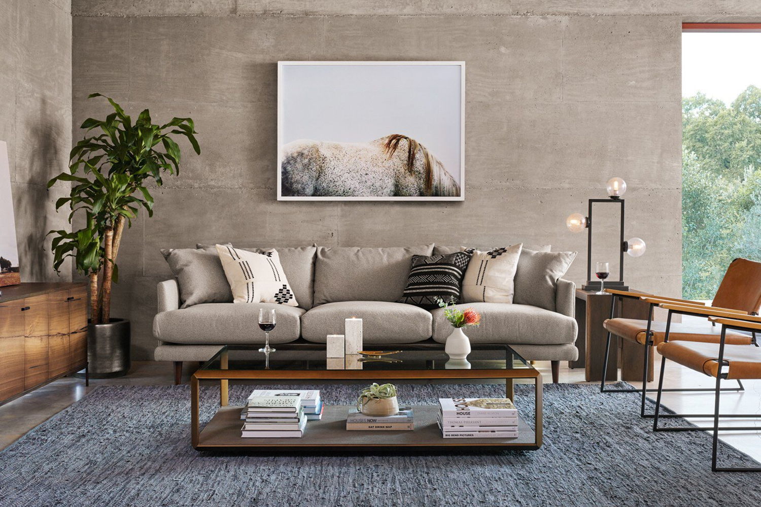 Modern living room with a sofa, coffee table, and plant.