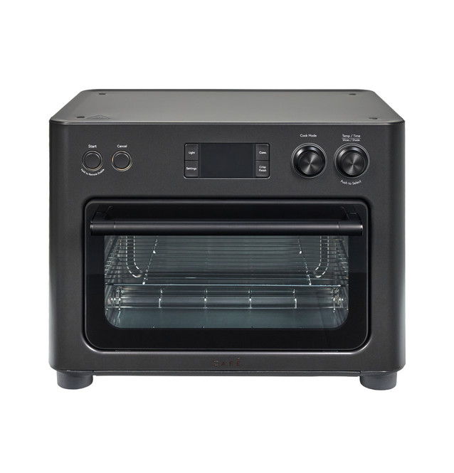 Black countertop oven with digital display and control knobs.