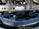 Engine bay front grille install four black train horn trumpets blue solenoid valve Mike's 2004 Chevrolet Impala Conductor's Special 544 Nightmare Edition HornBlasters customer install gallery photo 2