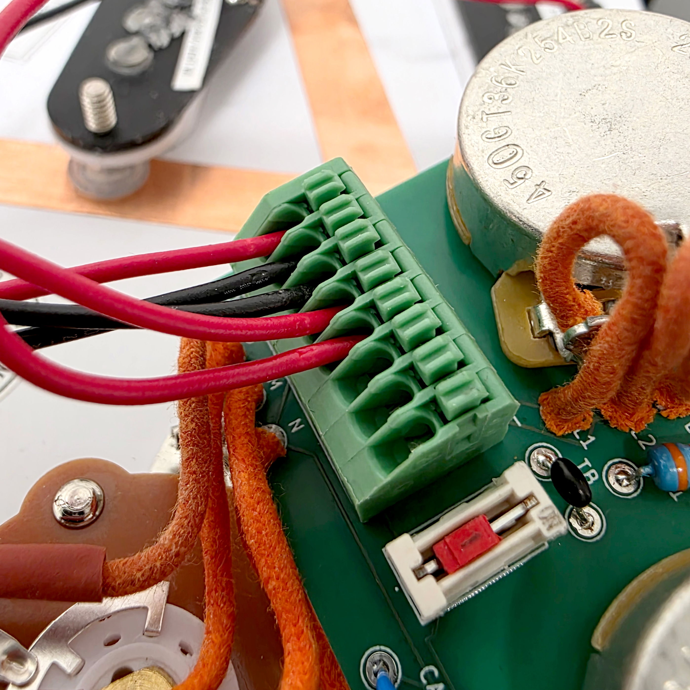 Close-up of electronic circuit board with wires and connectors.