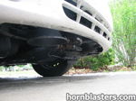 Large black train horn tucked behind front bumper low angle 2001 Toyota Corolla Nathan AirChime K5LA gallery photo 6