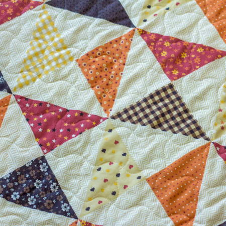 detail of wavy quilting on a quilt with triangles