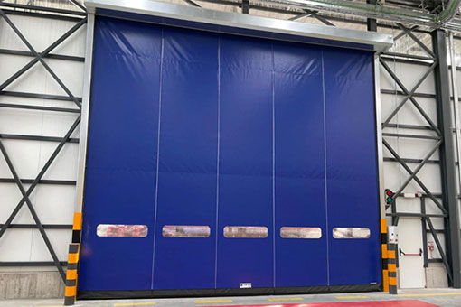Large blue industrial door in a warehouse setting.