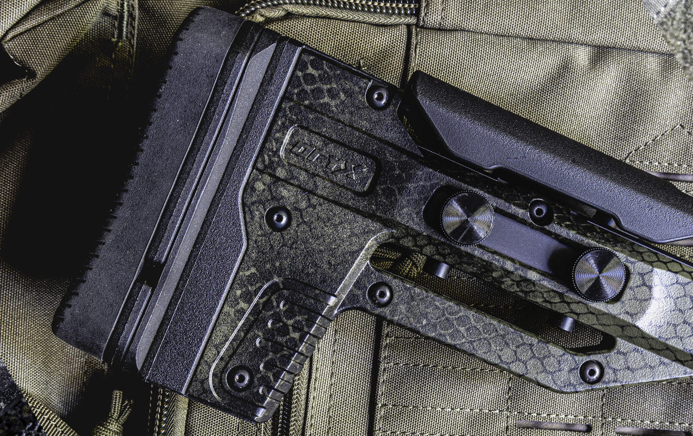 Close-up of a tactical firearm stock on fabric background.