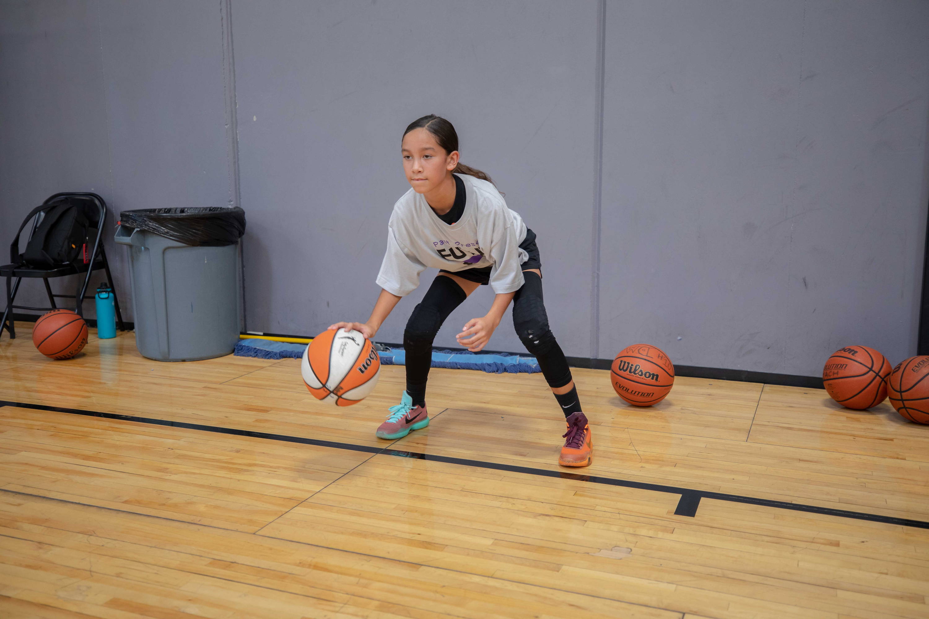 heroes basketball league girl dribbling a basketball