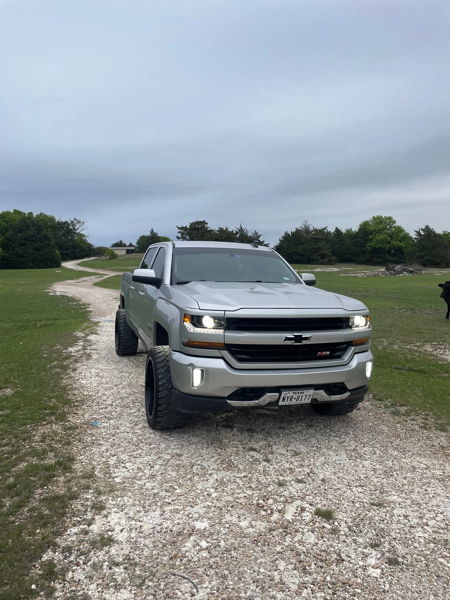 Front three-quarter silver 2018 Chevrolet Silverado 1500 Z71 on gravel road with green field Jackson's HornBlasters Outlaw 228H train horn kit install photo 1