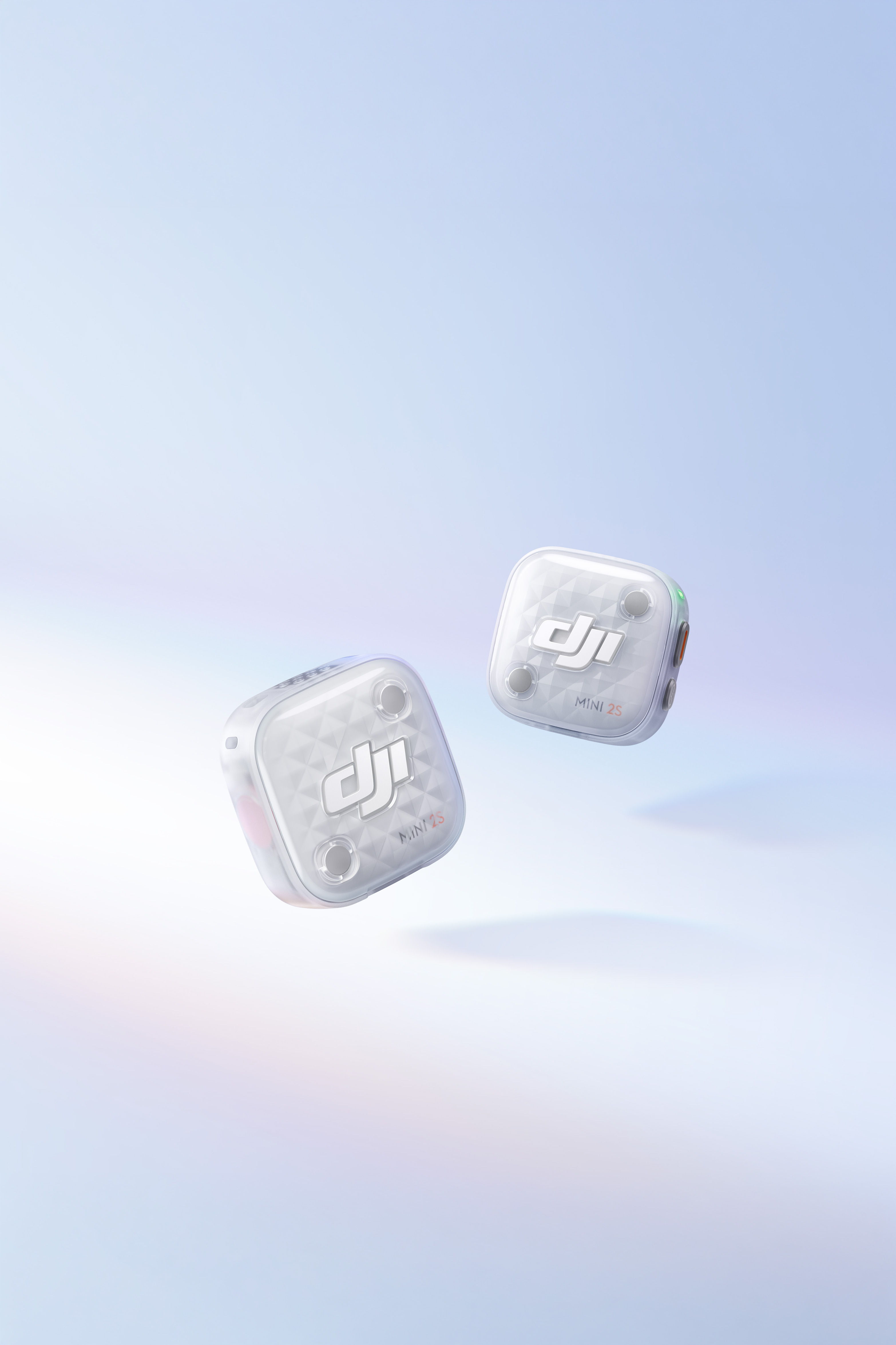 Two DJI Mic Mini 2S floating against a soft blue gradient background.