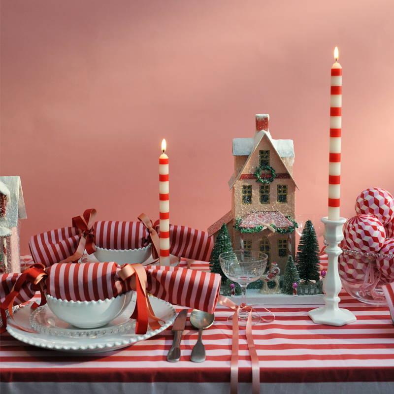A pink and red striped laid Christmas table snapshot.