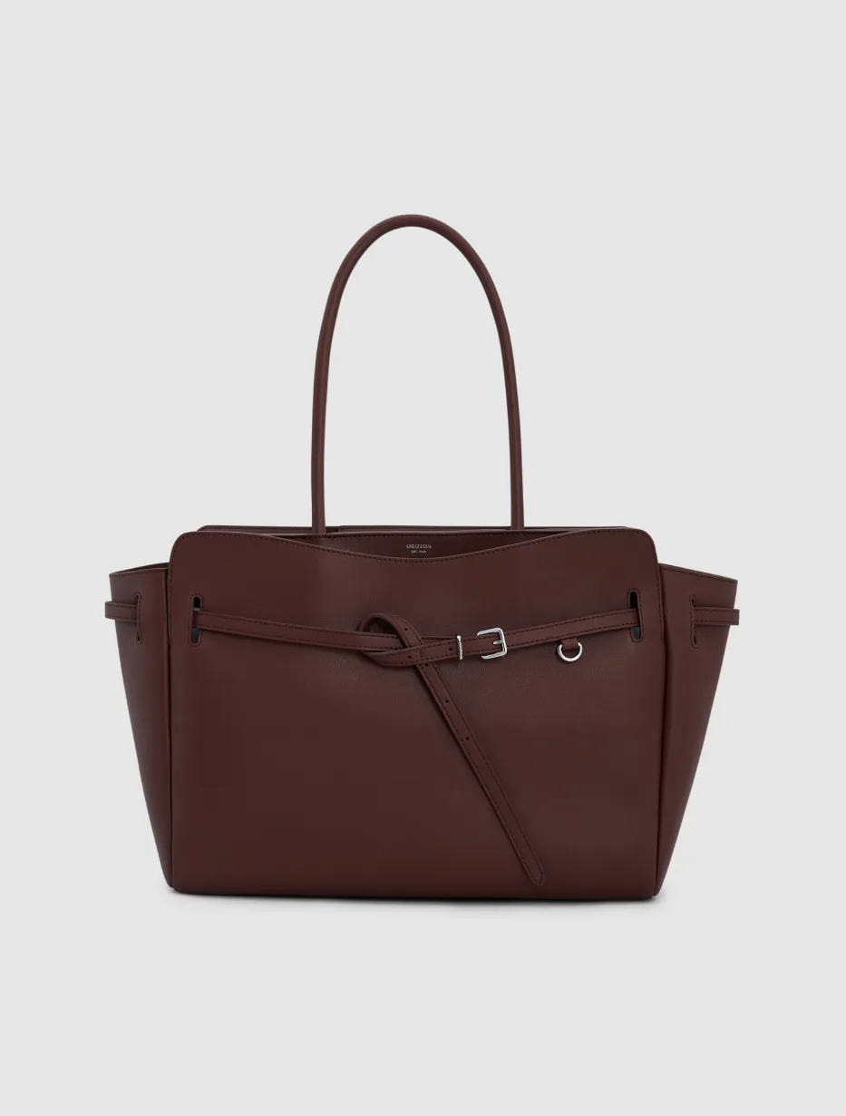 Brown leather handbag with two handles and a zipper pocket.
