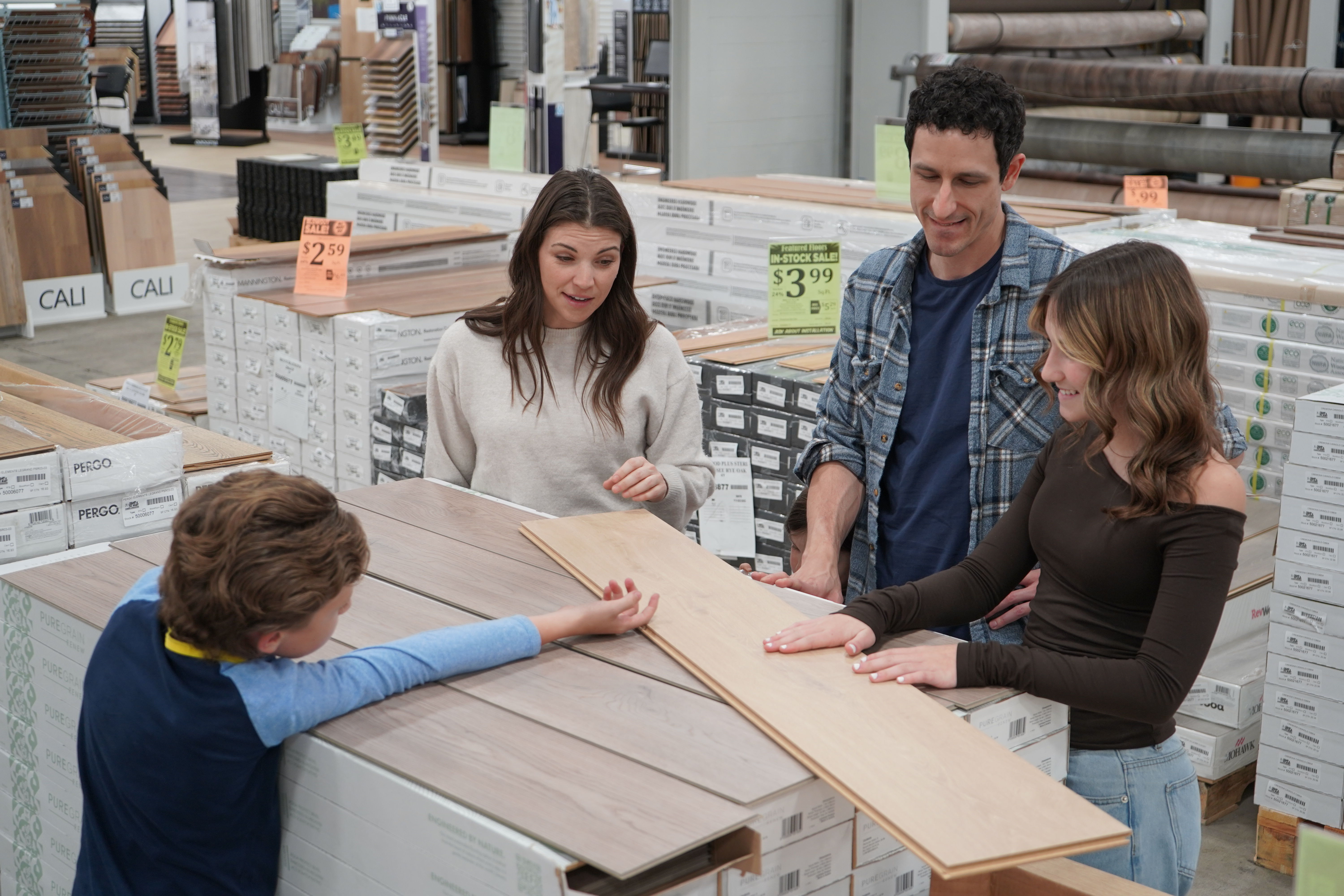 family looking at flooring options in store