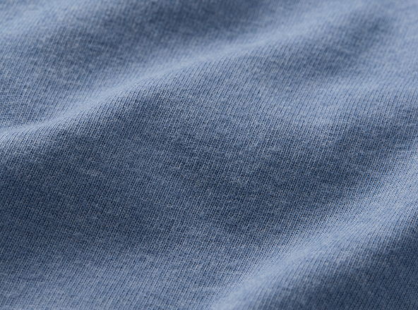 Close-up of textured blue fabric with soft, wrinkled appearance.