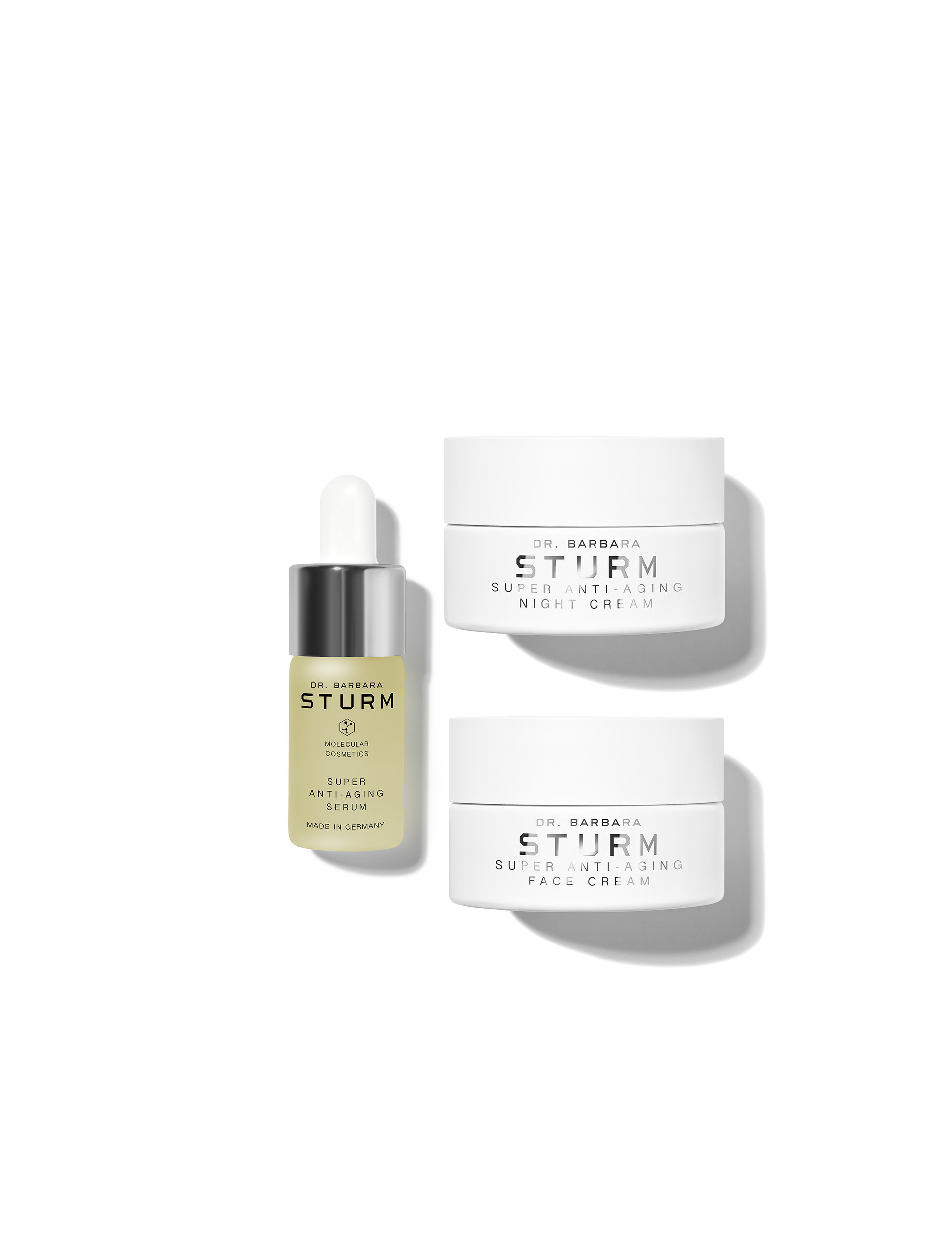 Skincare products including a serum and two cream jars.