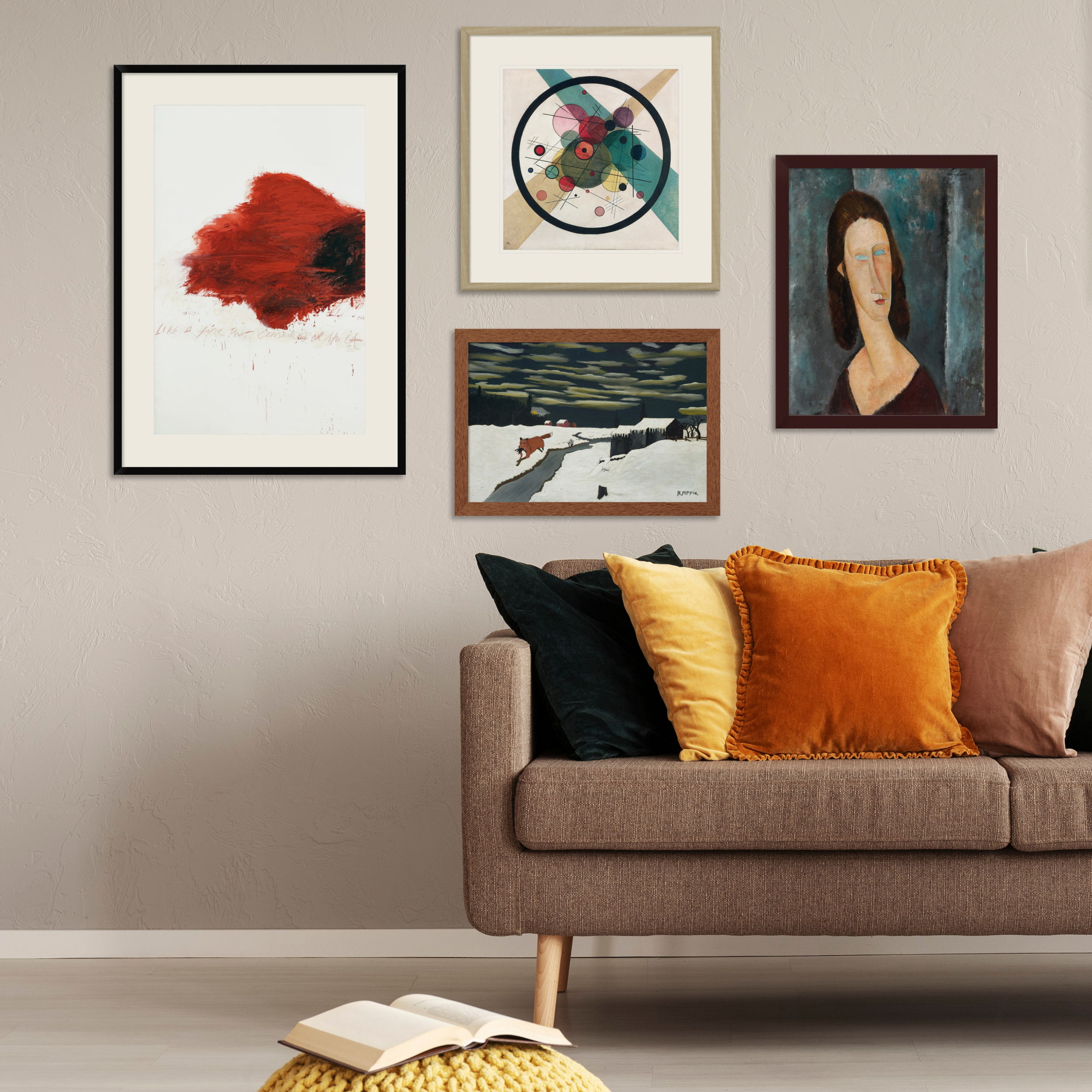 Living room with artwork on the wall above a cozy sofa with cushions.