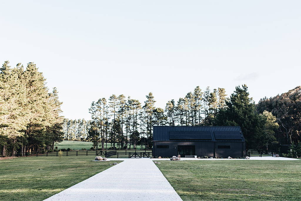 The Highlands Black Barn and surrounding trees.