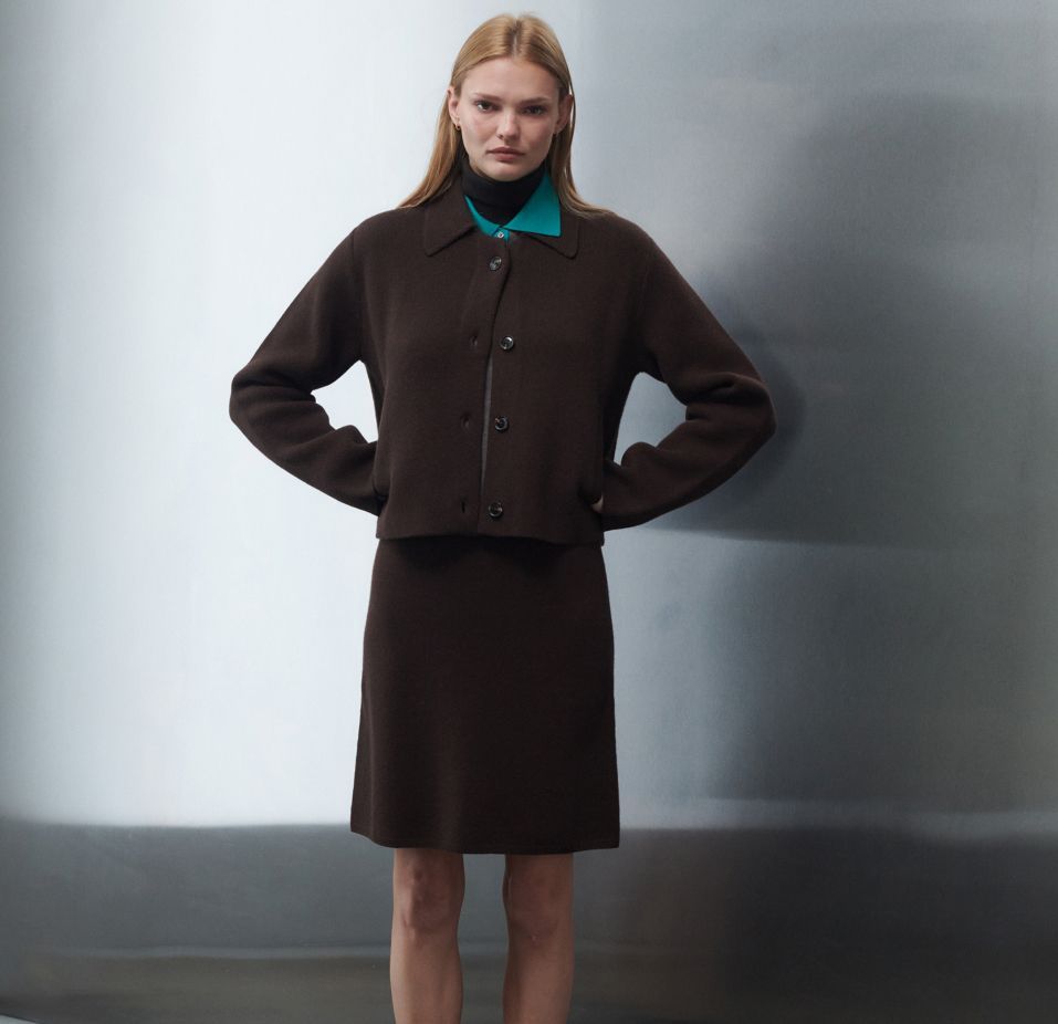 Woman standing with hands in pockets