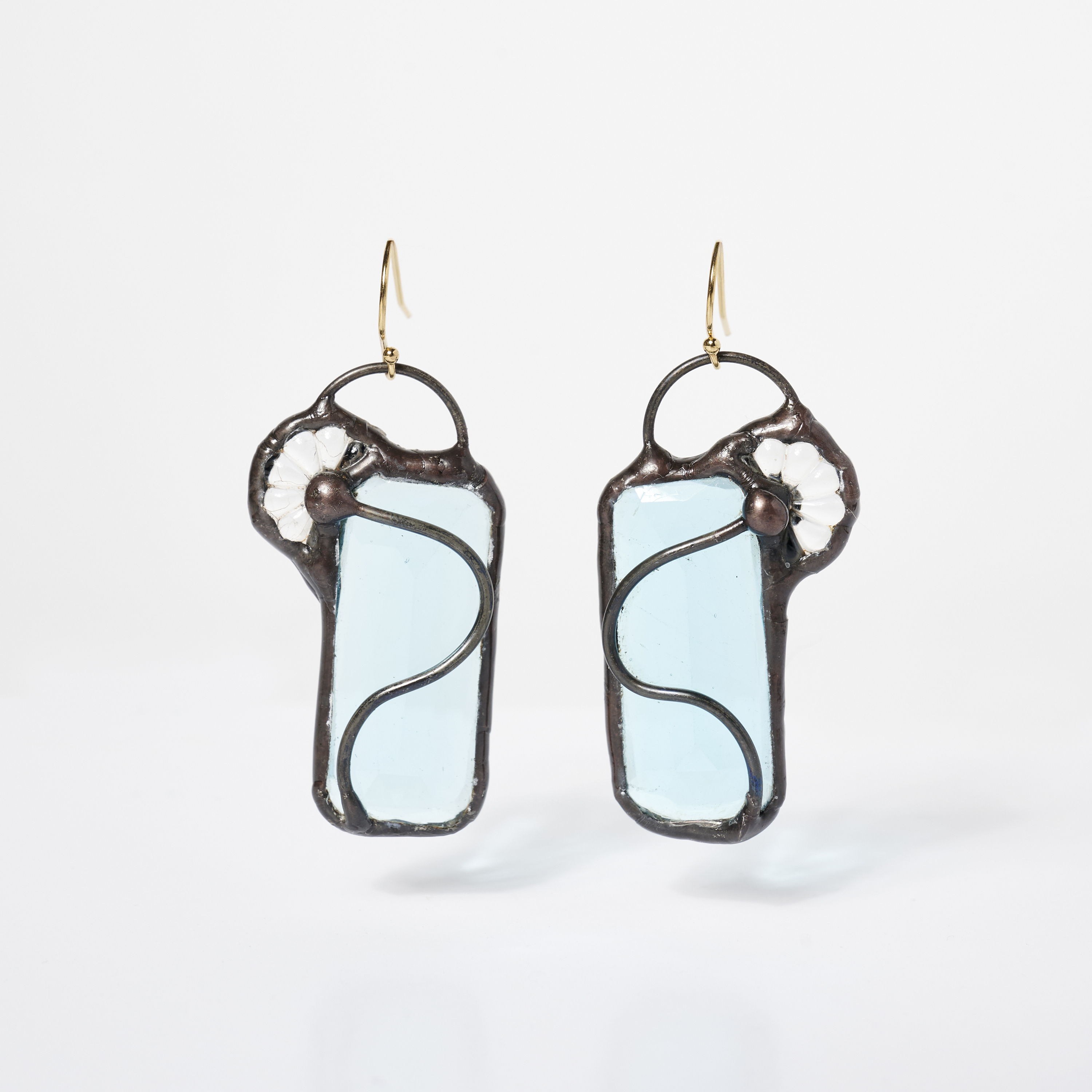 Pair of elegant blue glass earrings with intricate metalwork.