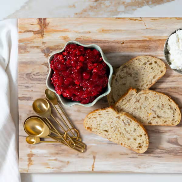 closeup making cranberry chevre crostini 