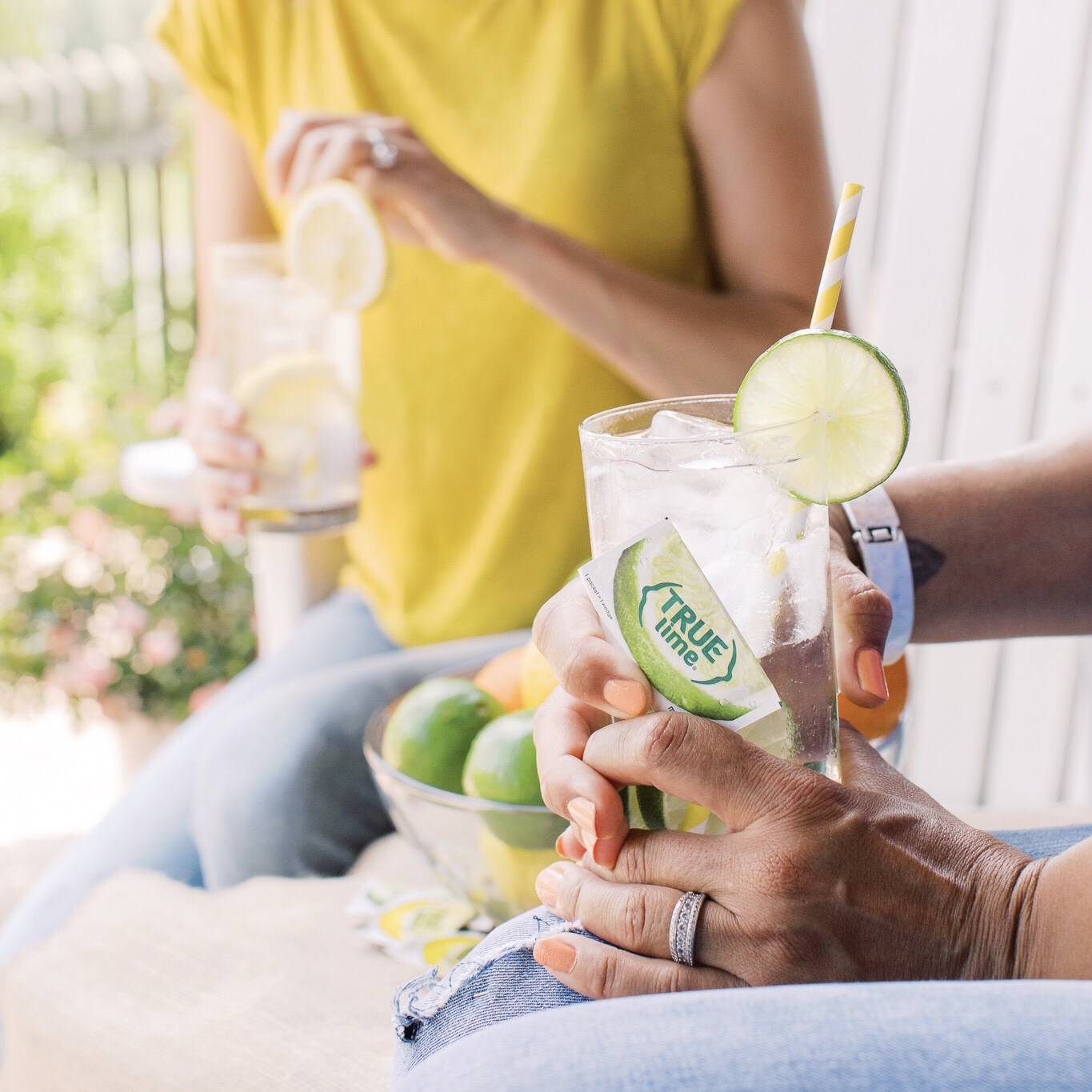 Friends sitting on porch drinking true lime