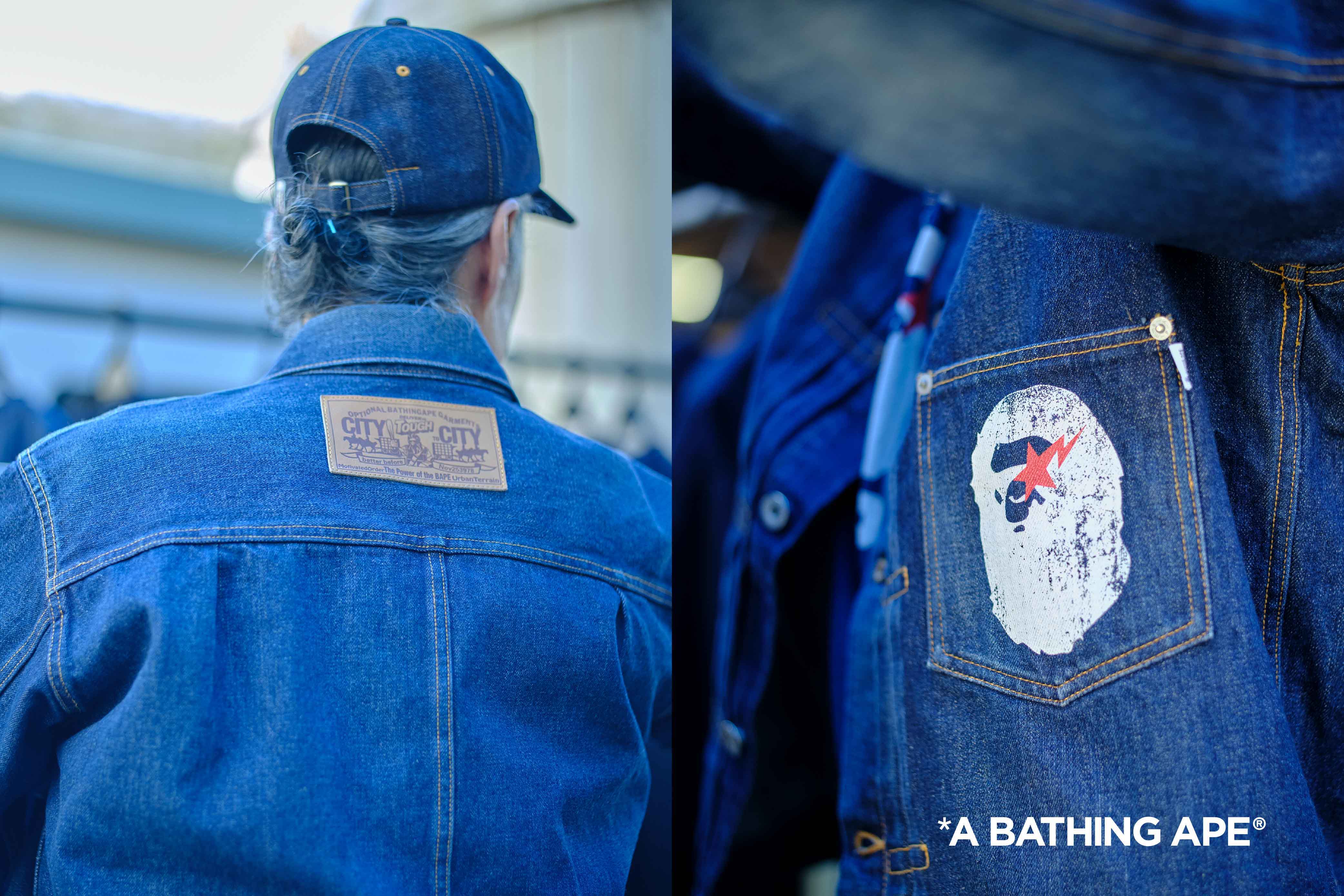 Person wearing a denim jacket with a patch and label on the back.