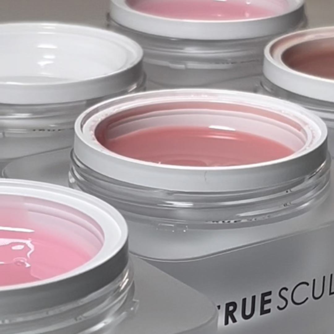 Jars of pink and nude gel polish with white lids.