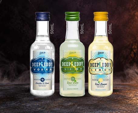 Three bottles of Deep Eddy Vodka in different flavors.