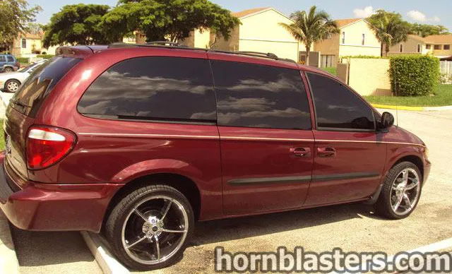 Rear three-quarter maroon Dodge Caravan Grand Cargo chrome wheels tinted windows palm trees residential Leonard's Conductor's Special 232 featured gallery photo 1