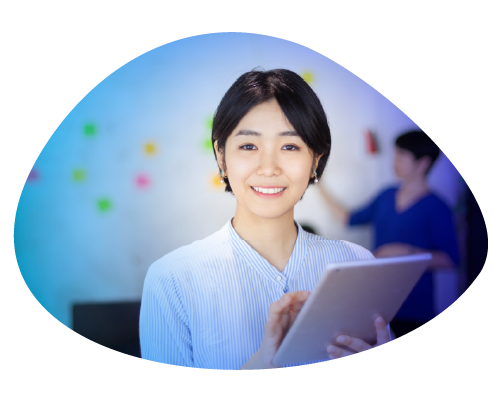 Smiling woman holding a tablet, with a colorful background.