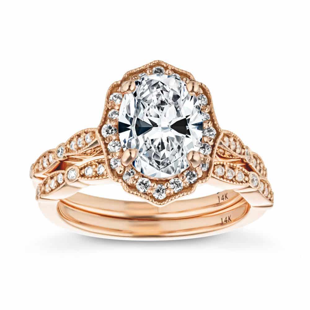 antique and vintage style wedding set with diamond accenting and fine elegant details featuring an oval cut lab diamond engagement ring in rose gold
