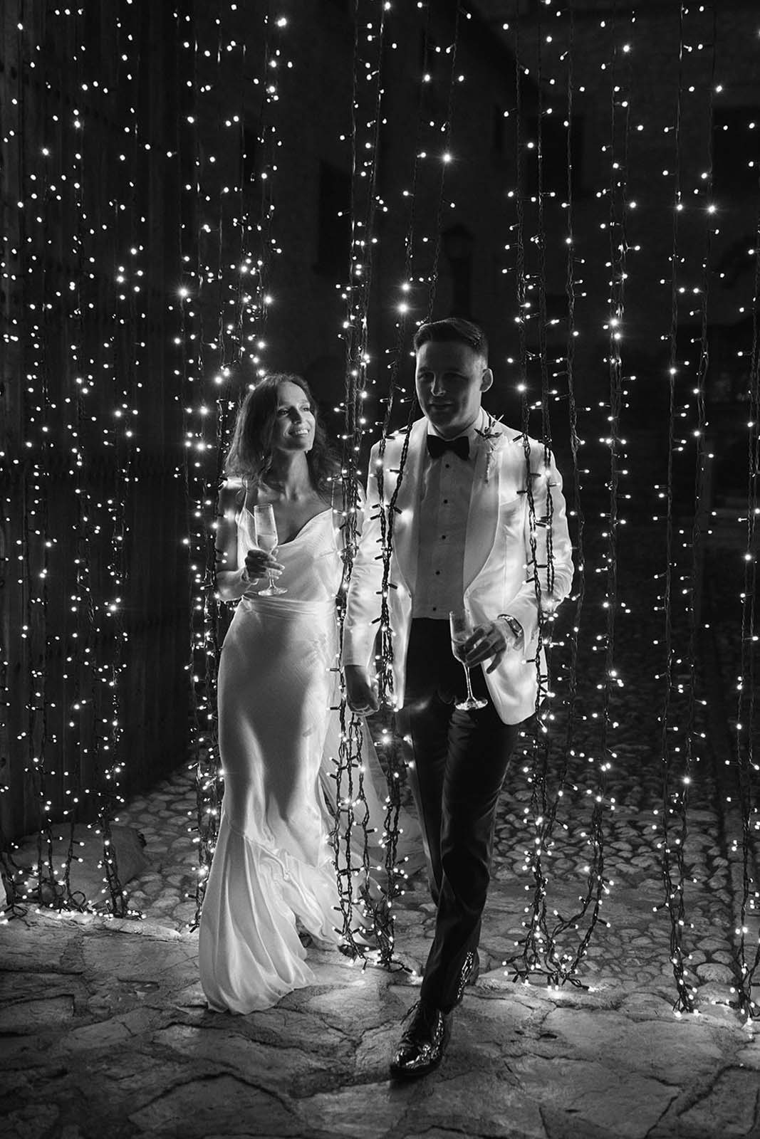 Bride and groom, surrounded by fairy lights