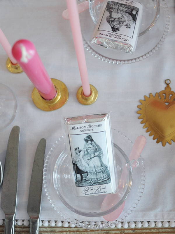 An overhead image of a Maison Bouche wedding chocolate bar in an empty pearl glass tea cup and saucer.