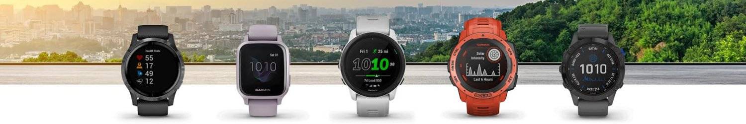 Several Garmin smartwatches in front of a city landscape