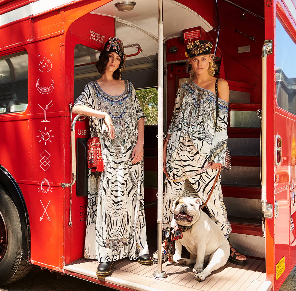 Models in bus wearing CAMILLA black and white kaftan, tee and pants