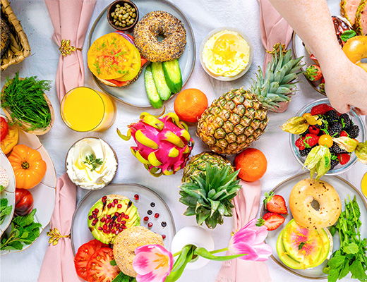 A colorful spread of fruits and pastries on a table.
