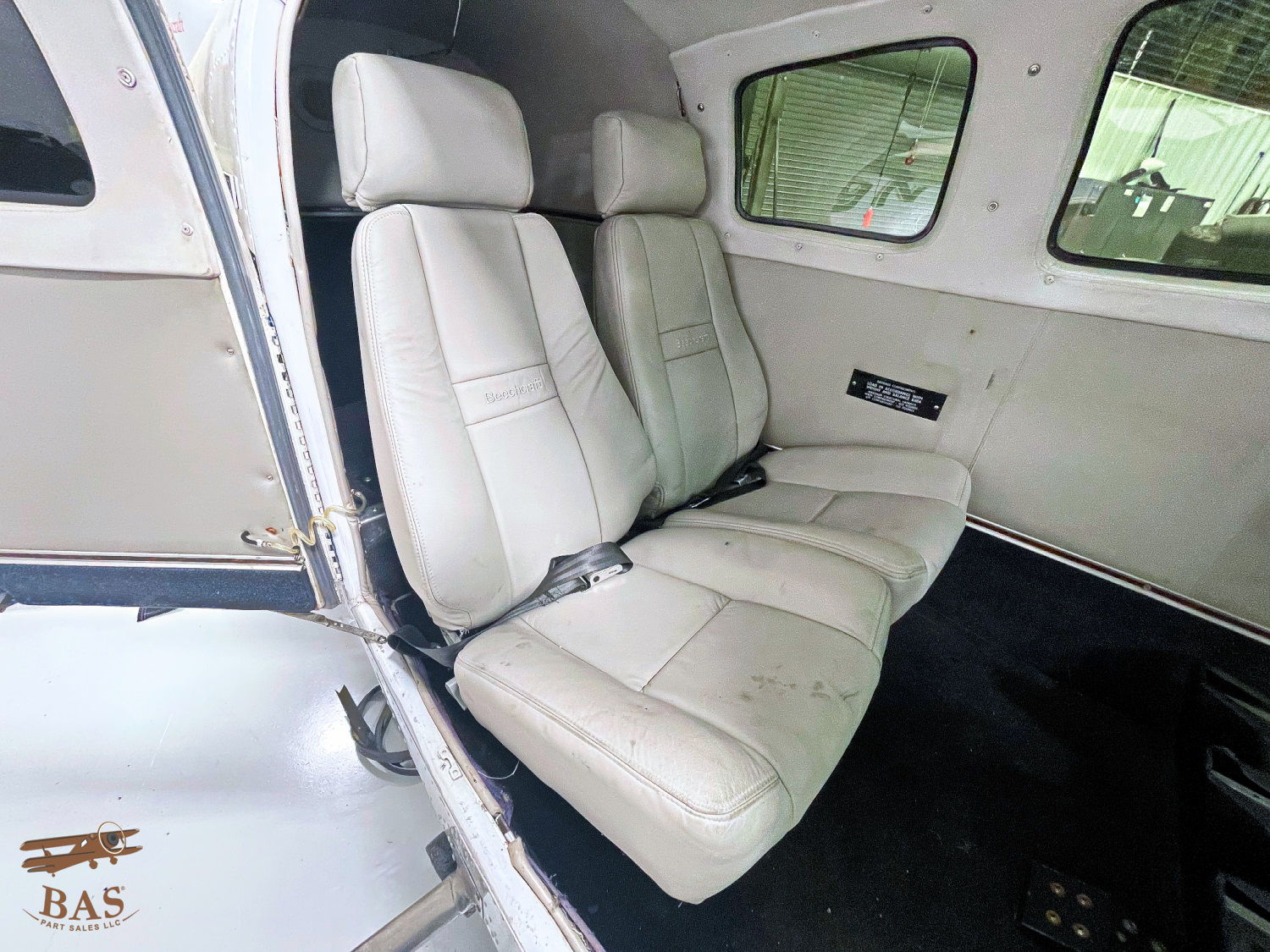 Interior view of two white airplane seats.